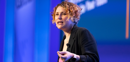 Speaker presenting at Gartner conference, emphasizing data-driven research and expert insights.