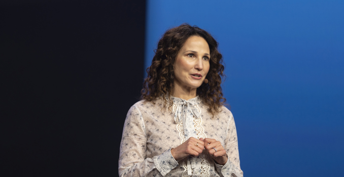 Speaker presenting at Gartner conference, emphasizing data-driven research and expert insights.