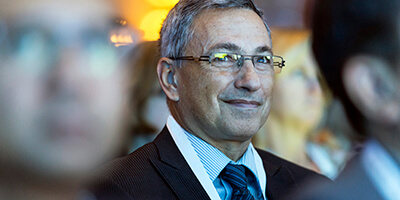 Speaker presenting at Gartner conference, emphasizing data-driven research and expert insights.