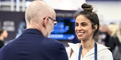 Attendees networkign with exhibitors