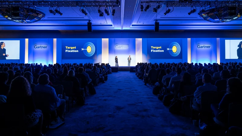 Both sides of the audience seated during the Gartner Keynote session, with the speaker and presentation visible on stage.