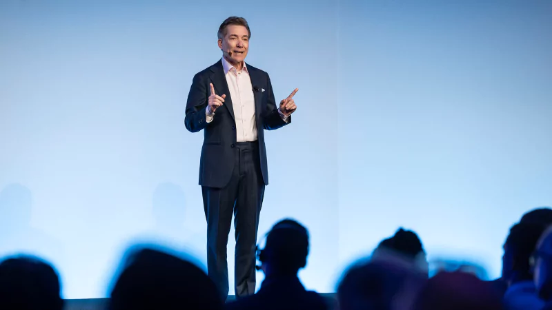 Speaker presenting at Gartner conference, emphasizing data-driven research and expert insights.