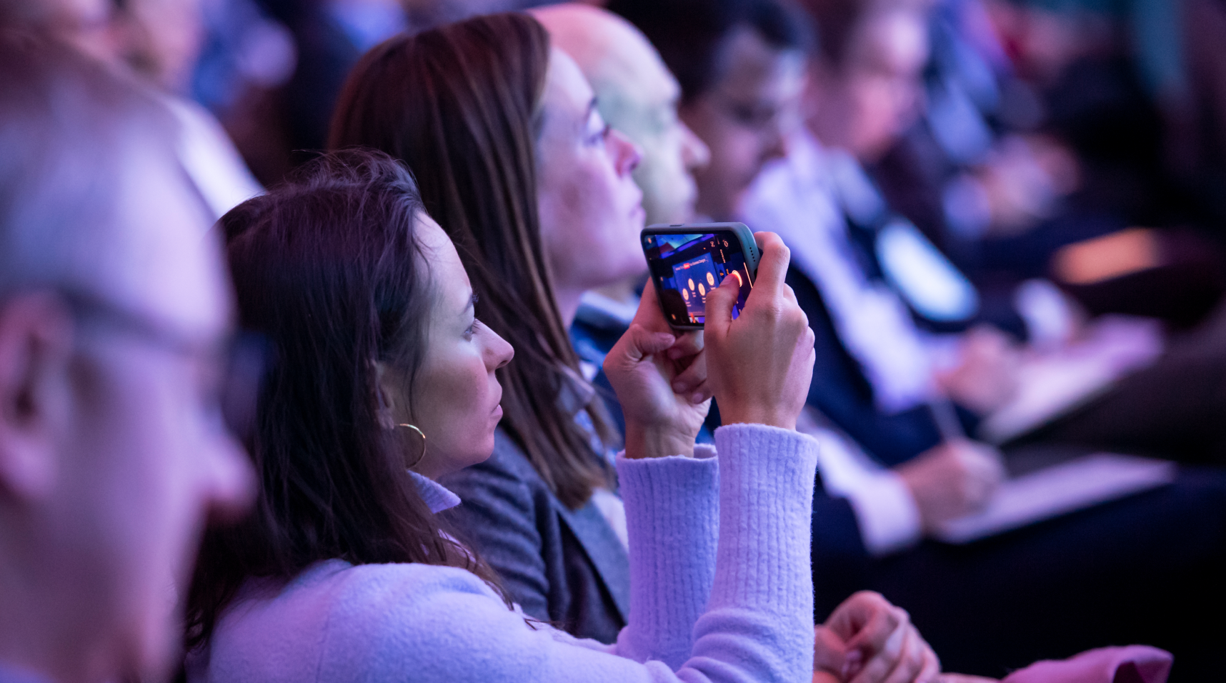 Attendee taking a picture of the stage