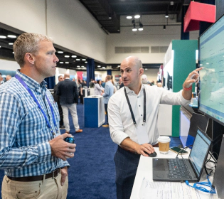 Gartner attendees networking across the conference and studying Gartner screen taking a deeper dive into supply chain.