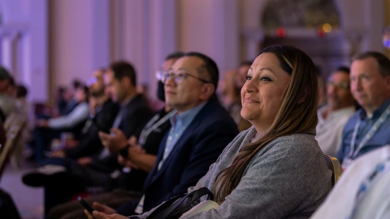 Attendee smiles engaged in the keynote at Gartner Application Innovation Summit