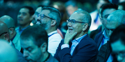 Speaker presenting at Gartner conference, emphasizing data-driven research and expert insights.