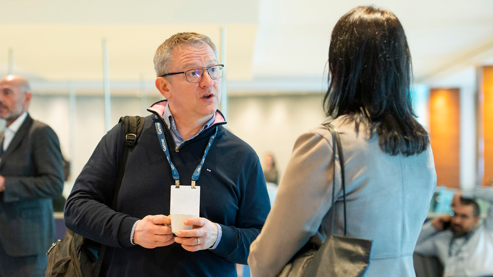 Attendees networking with digital workplace peers at Gartner Digital Workplace Summit, in the audience of a conference session.