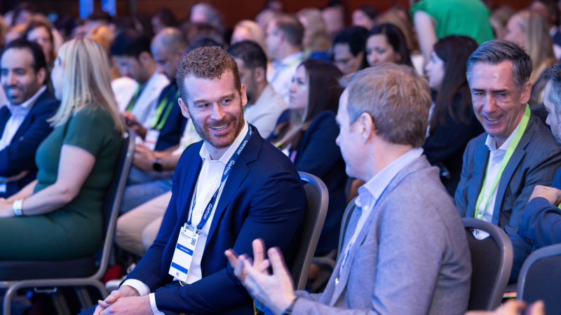 Speaker presenting at Gartner conference, emphasizing data-driven research and analyst insights.