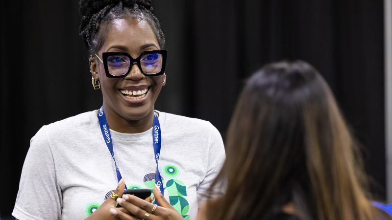 Gartner Apps Summit attendee smiling interacting with vendor