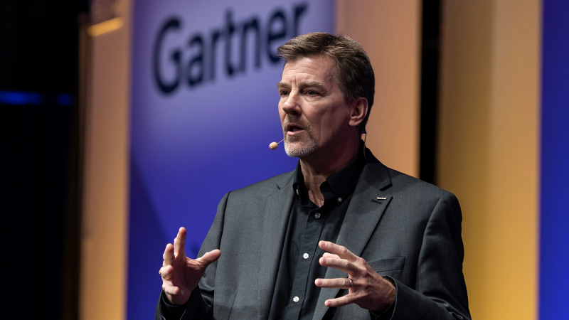 Speaker delivering keynote at Gartner conference, offering visionary insights and innovative perspectives.