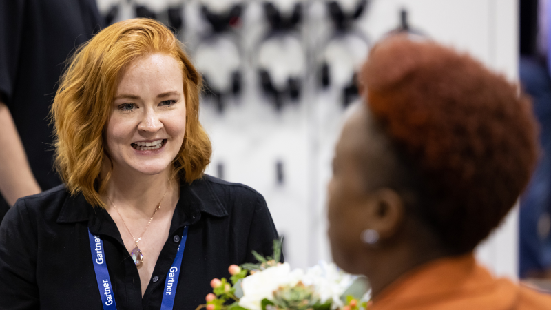 Attendees discussing solutions at Gartner conference, tackling challenges with peers and experts.