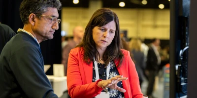 Two people discussing a 30-, 60-, and 90-day action plan to tackle major HR challenges