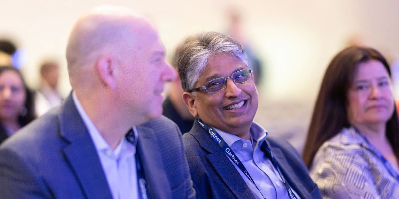 Speaker presenting at Gartner conference, emphasizing data-driven research and expert insights.
