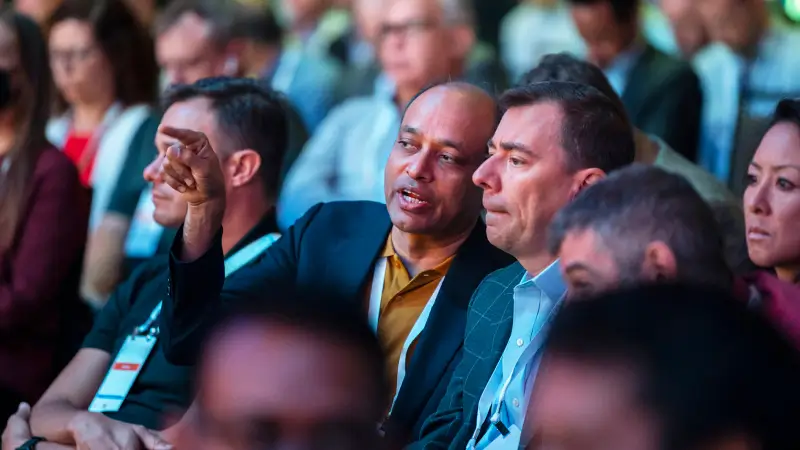 Attendees discussing solutions at Gartner conference, tackling challenges with peers and experts.