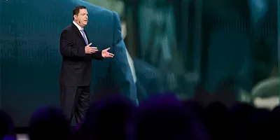 Speaker delivering keynote at Gartner conference, offering visionary insights and innovative perspectives.