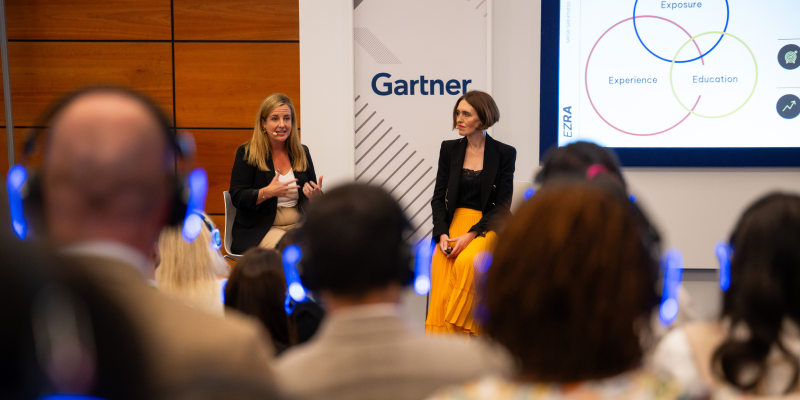 Speaker presenting at Gartner conference, emphasizing data-driven research and expert insights.