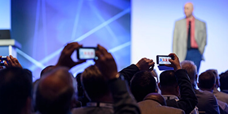 Speaker presenting at Gartner conference, emphasizing data-driven research and expert insights.