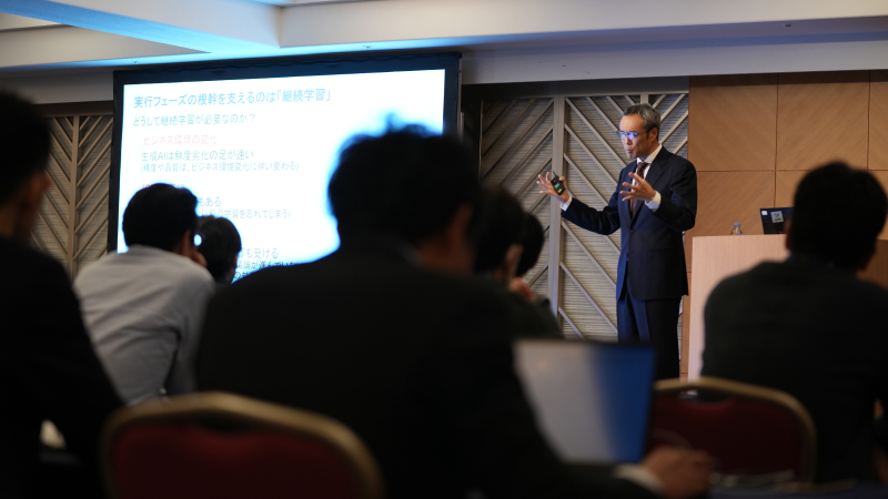 Speaker presenting at Gartner conference, emphasizing data-driven research and expert insights.