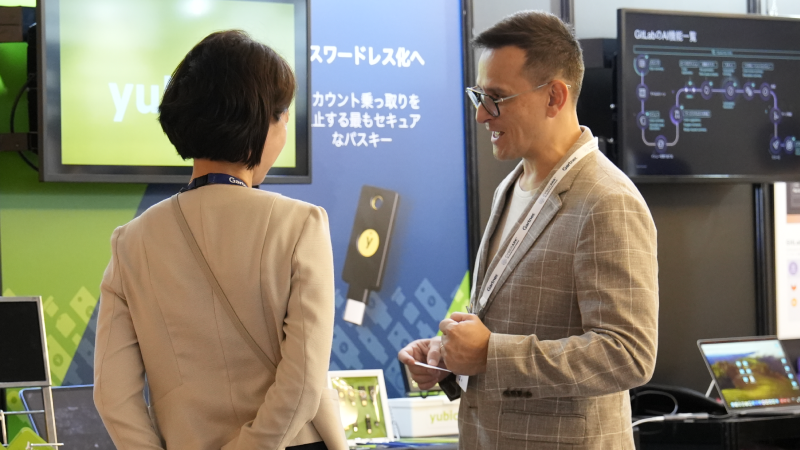 People at Gartner Application Summit talk to exhibitors