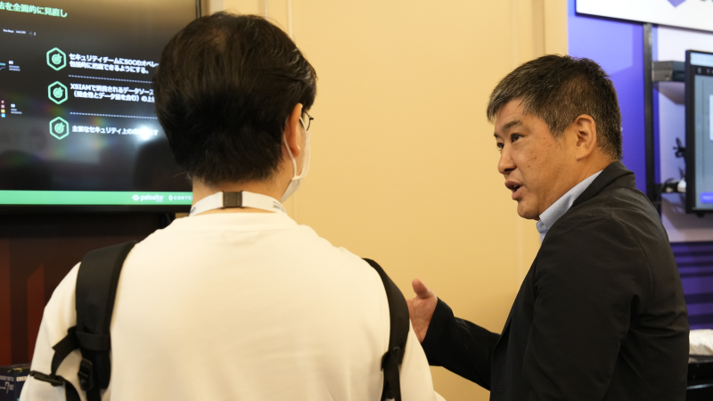People at Gartner Application Summit talk to exhibitors