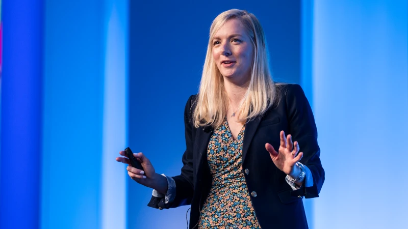 Speaker presenting at Gartner conference, emphasizing data-driven research and expert insights.