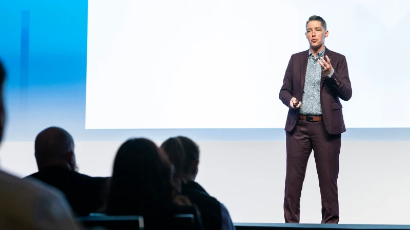 Gartner expert Tori Paulman speaking on stage at Gartner Digital Workplace Summit, in front of an audience of digital workplace leaders.