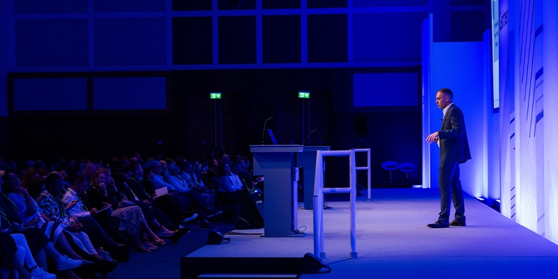 Speaker delivering keynote at Gartner conference, offering visionary insights and innovative perspectives.