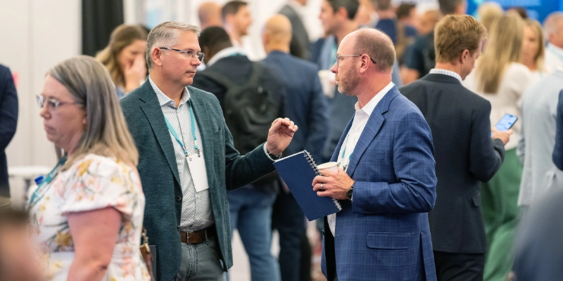 Attendees discussing solutions at Gartner conference, tackling challenges with peers and experts.