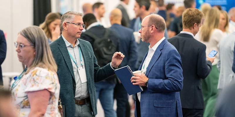 Attendee speaking with technology solution providers at Gartner IT Symposium/Xpo on the Gold Coast
