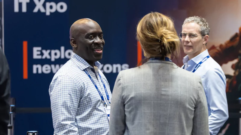 Attendee speaking with technology solution providers at Gartner IT Symposium/Xpo on the Gold Coast
