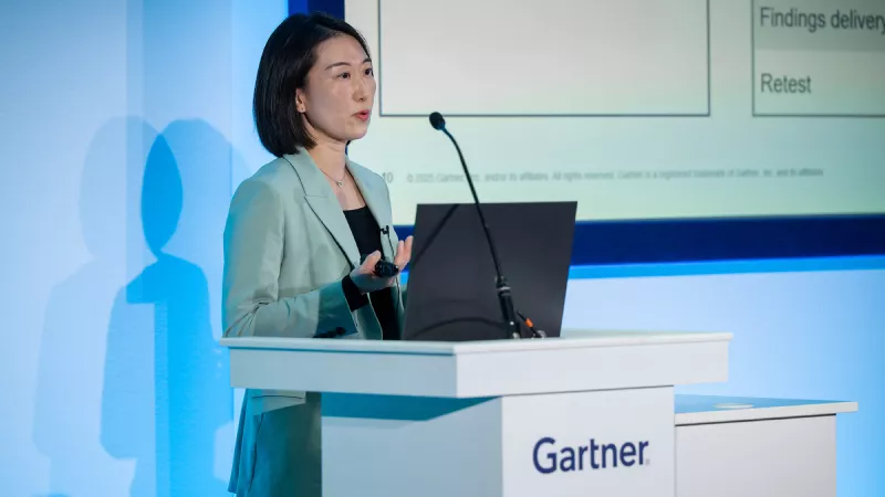 Speaker presenting at Gartner conference, emphasizing data-driven research and expert insights.