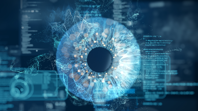 Technology and script reflected in a way that looks like an eye in a computer