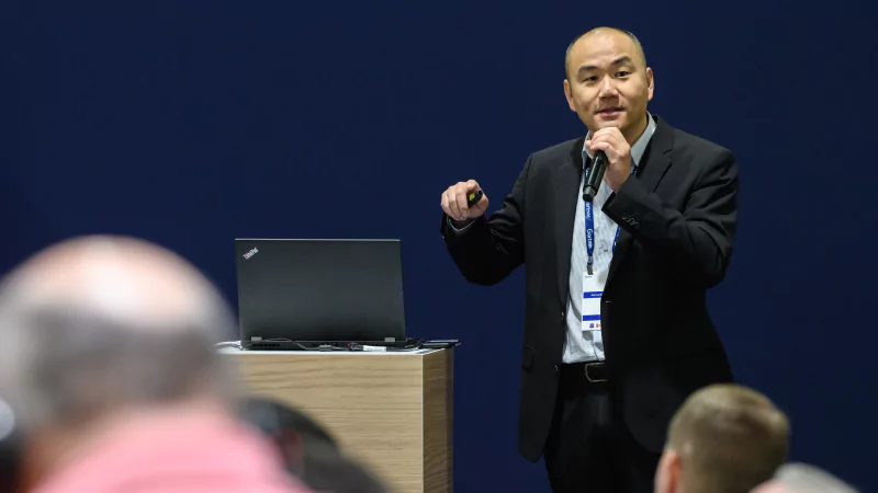 Speaker presenting at Gartner conference, emphasizing data-driven research and expert insights.