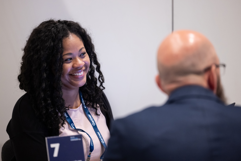 Attendee smiling in an interactive session with peers