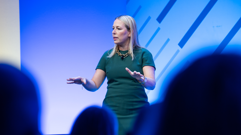 Speaker presenting at Gartner conference, emphasizing data-driven research and expert insights.